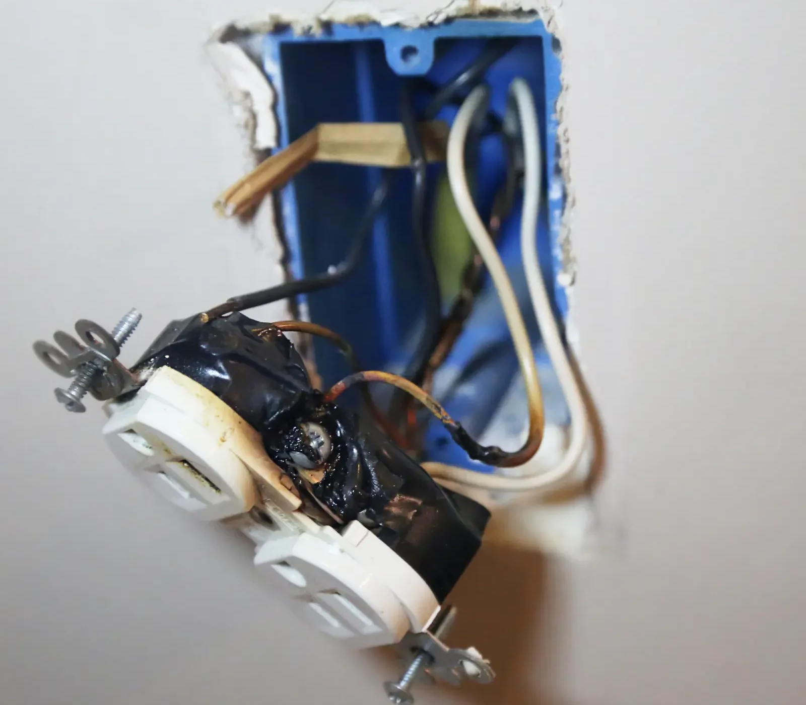 Burnt electrical outlet and wiring repair by licensed electrician